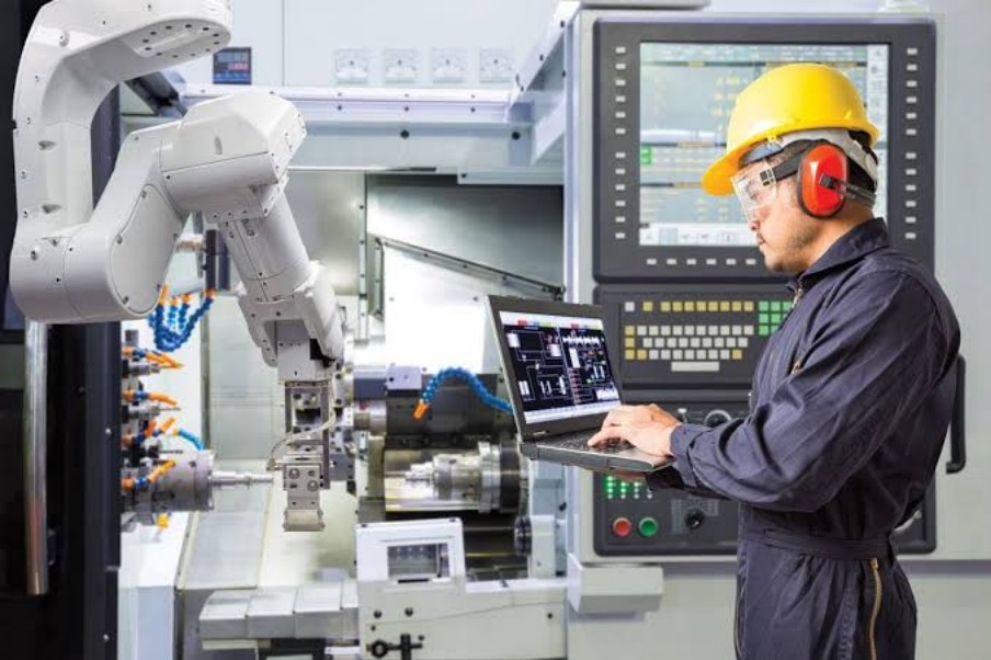 Engineer commissioning an automated machining cell
