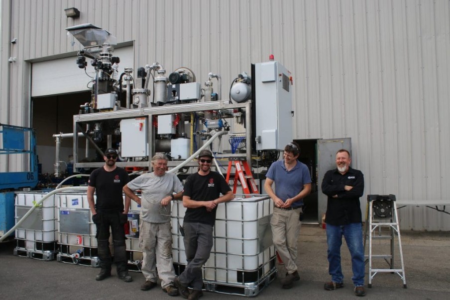 Site team with OEM process equipment outside a plant