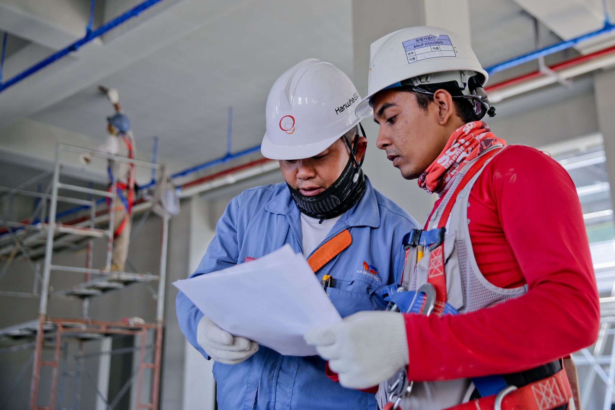 Engineers reviewing plans on an industrial construction site